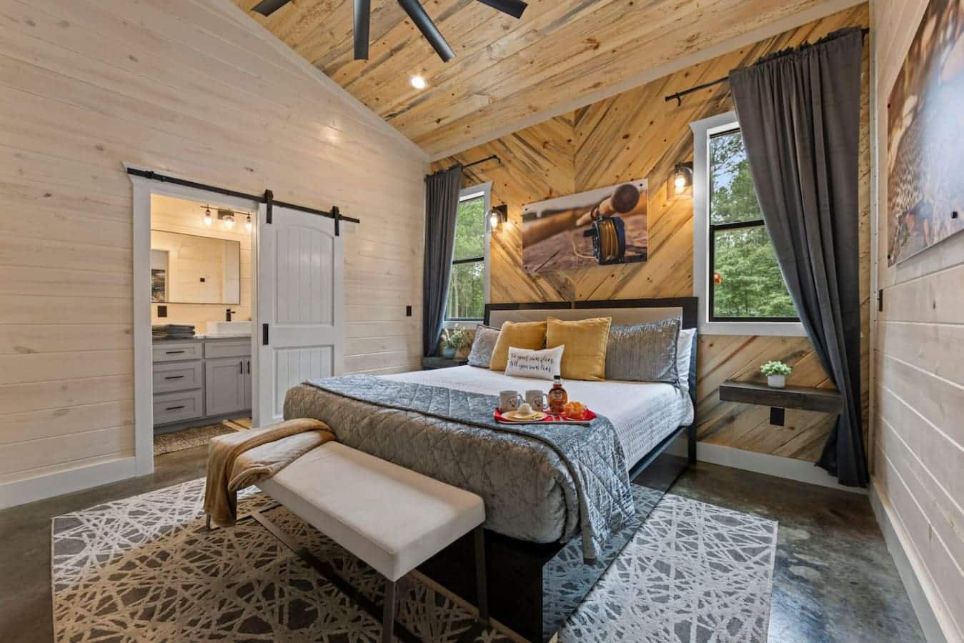 A serene rustic retreat: this cozy bedroom blends warm wood accents, soft lighting, and a spa-like bath just steps away — perfect for unwinding in style.