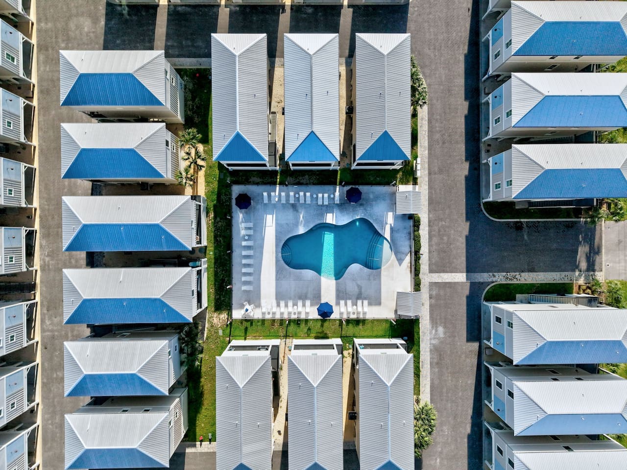From up here, you can see why everyone's fighting over these little beach houses with the bright blue roofs.