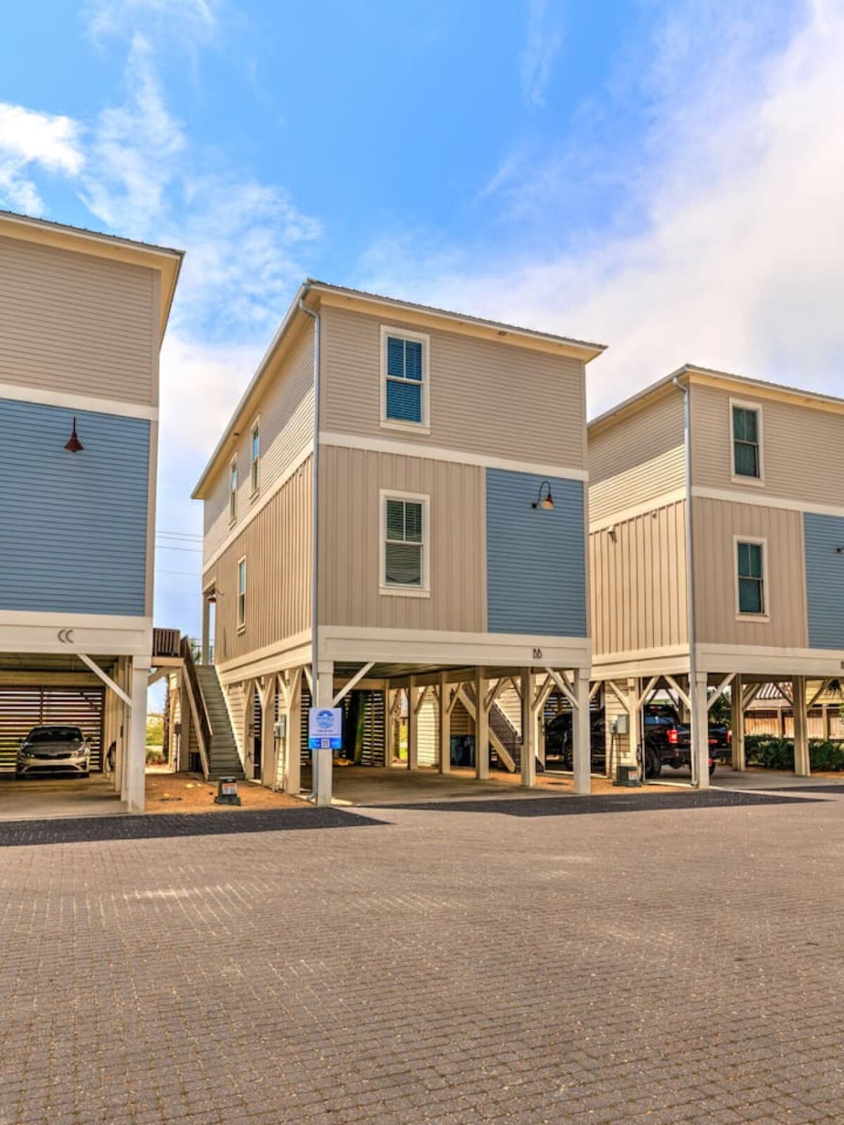 These elevated beach homes are giving serious coastal village vibes with that mix of modern finishes and classic stilts-on-sand charm that makes you feel like you're part of something special the moment you roll up.