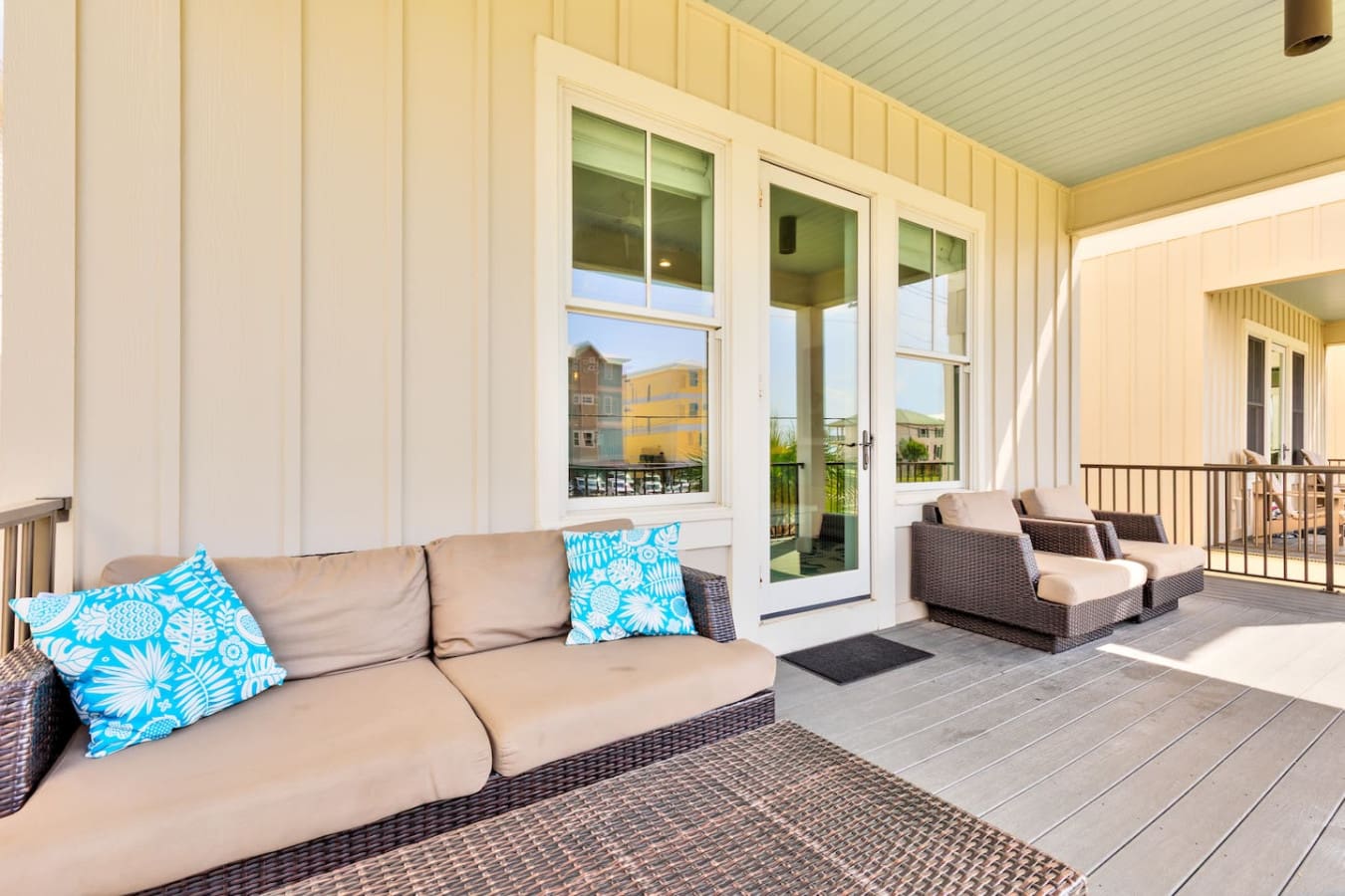 This covered porch is basically made for doing absolutely nothing but lounging in the sun with a view of the neighborhood, and honestly, that's the whole vacation right there.