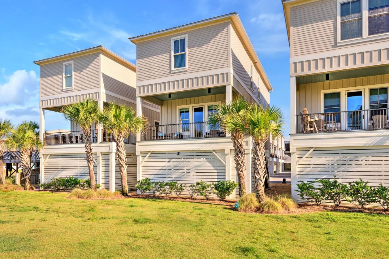 These elevated beach houses with their palm-lined yards and ocean views are basically the definition of a laid-back coastal escape.