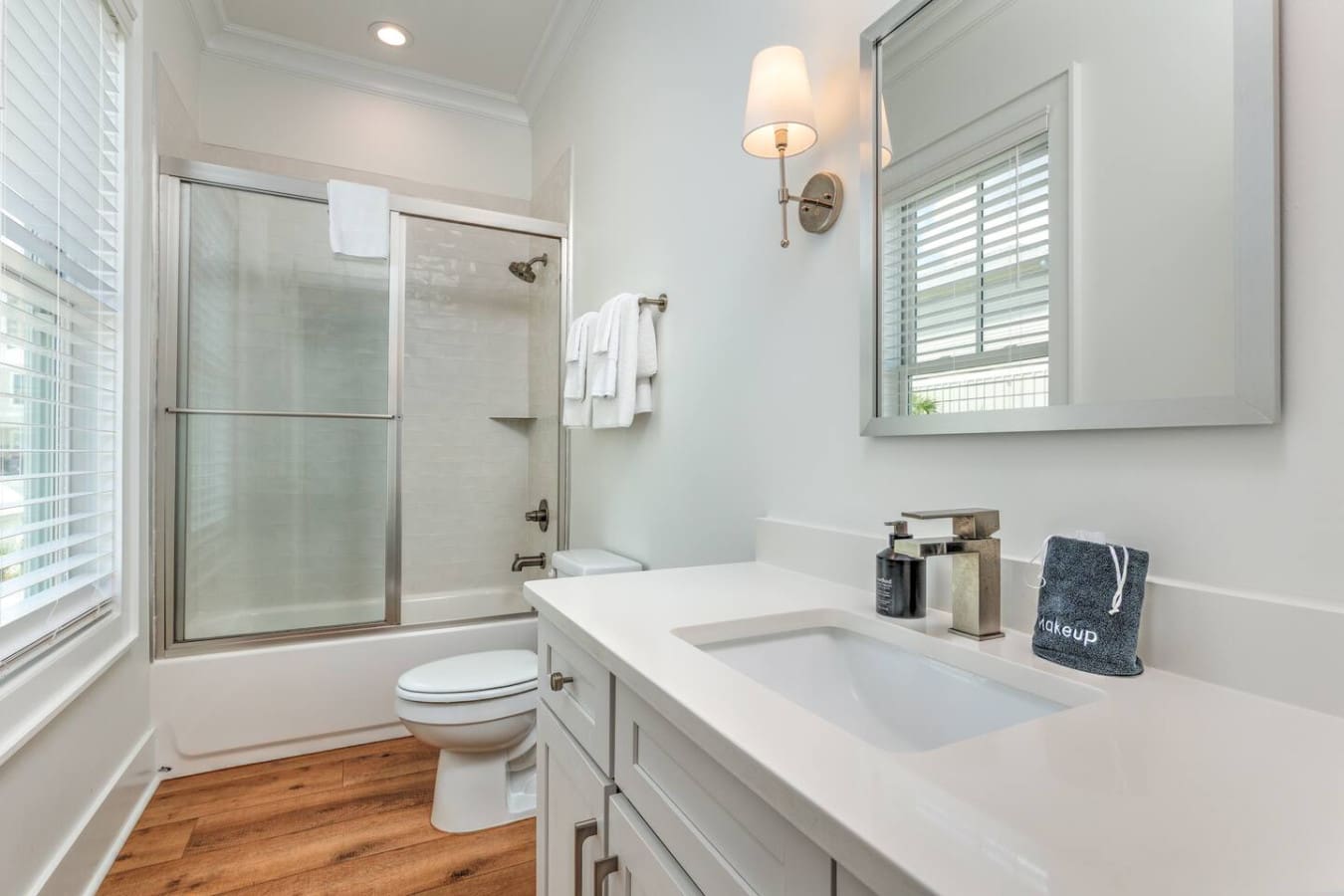 This bathroom is seriously giving clean and bright—white subway tile, modern fixtures, and plenty of counter space to actually spread out your stuff without it looking like a disaster.
