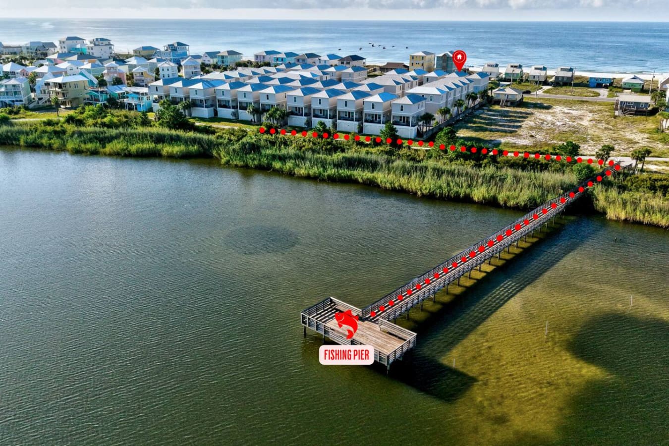 This little coastal community is basically your own private island setup—with a fishing pier, marsh views, and those cute blue-roofed homes all huddled together right where the water meets the beach.