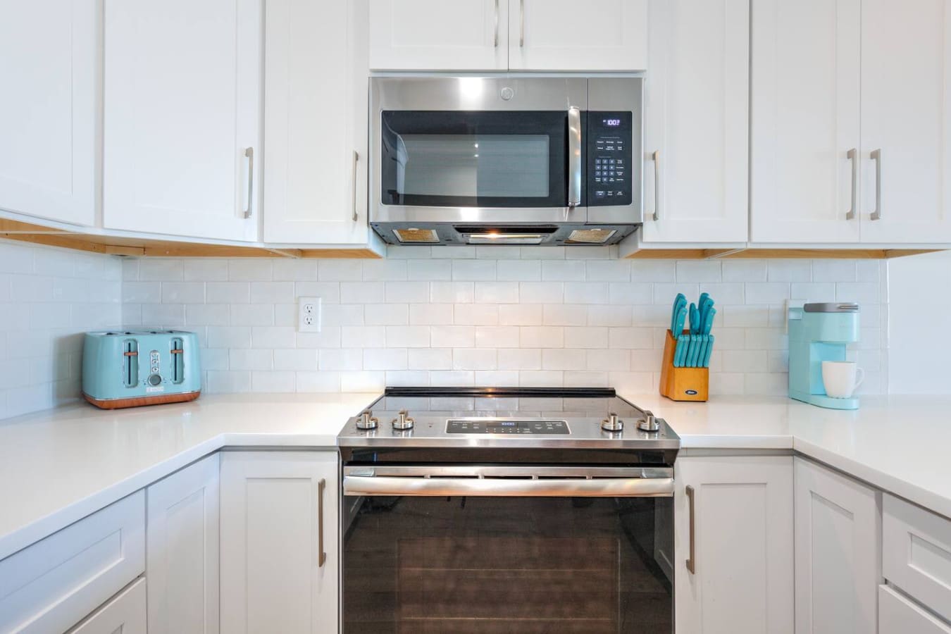 This kitchen's got all the modern appliances you'd actually want to use, clean white cabinetry, and that subway tile backsplash that just works—basically everything set up so you can actually enjoy cooking during your stay.