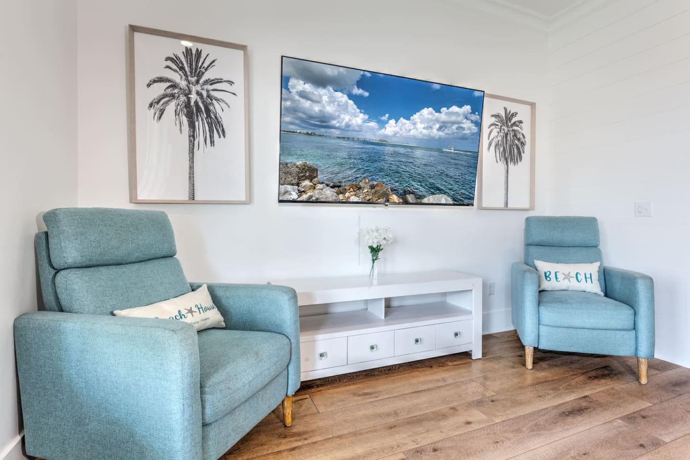 This living room is basically saying "kick back and stay awhile" with those comfy chairs facing the ocean view and beachy vibes everywhere you look.