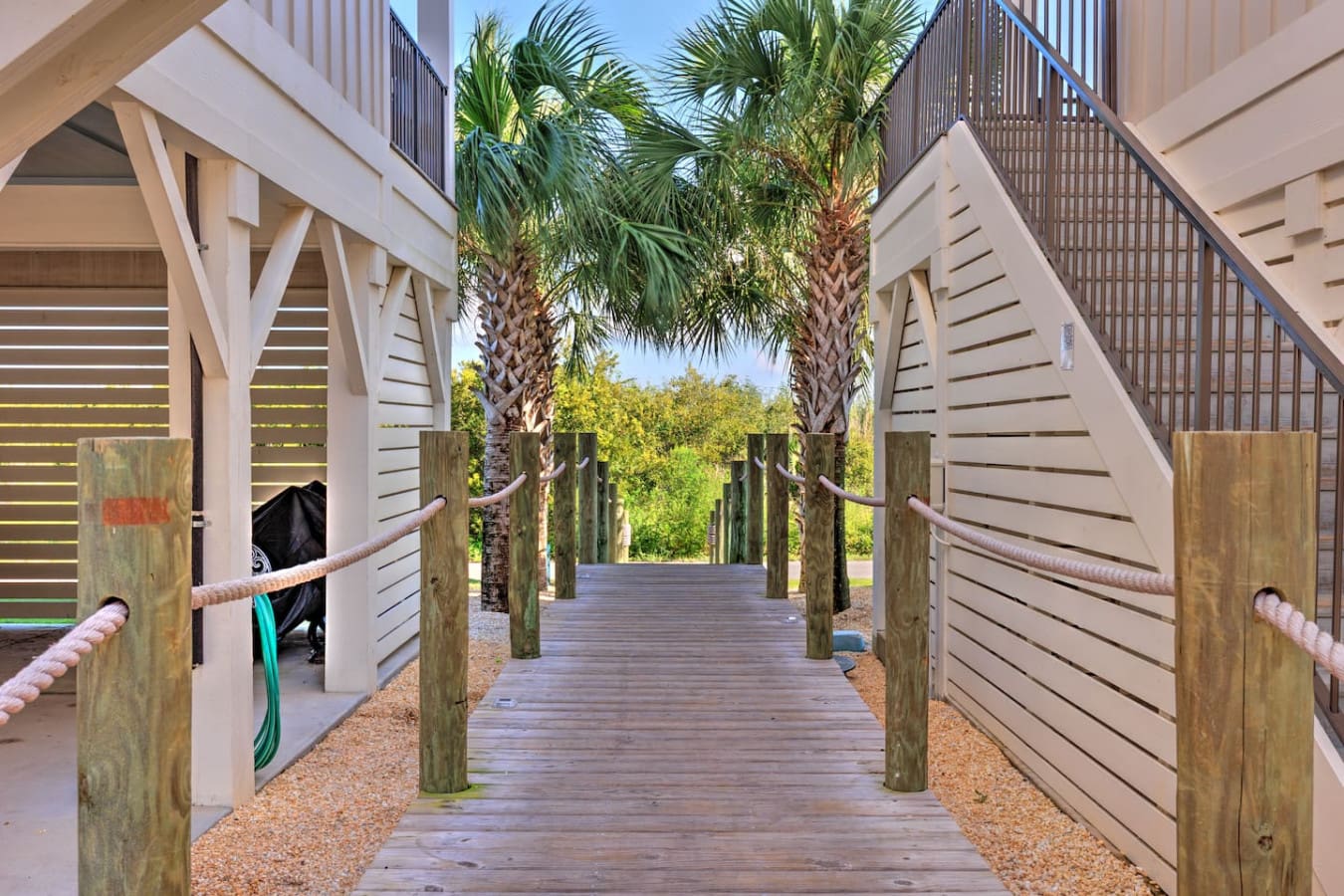 Walk straight through to those palm trees and you've basically got your own private beach gateway right from your doorstep.