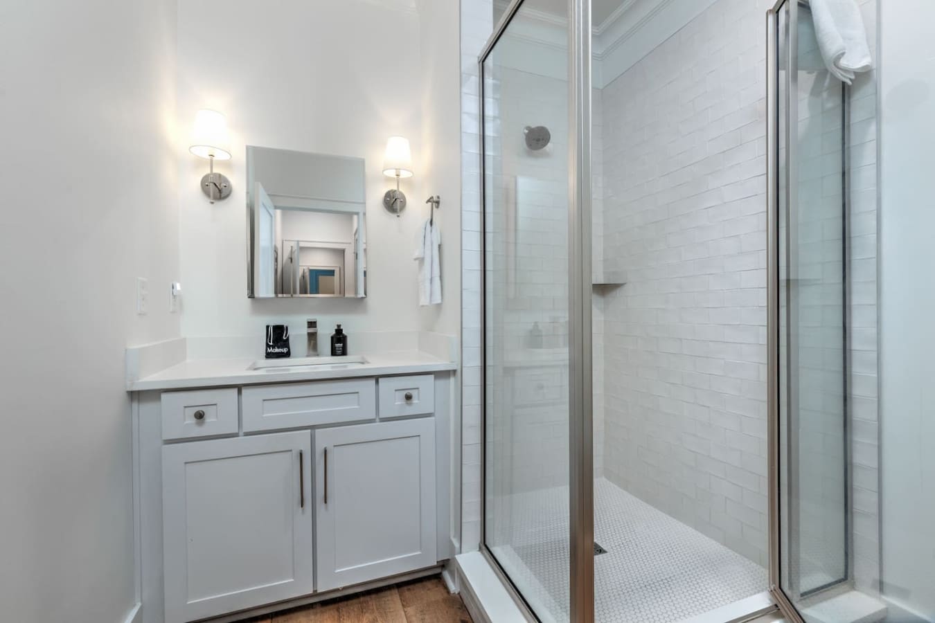 This spotless bathroom is exactly what you want after a day at the beach—fresh, bright, and with enough counter space to actually spread out your stuff without everything looking like a mess.