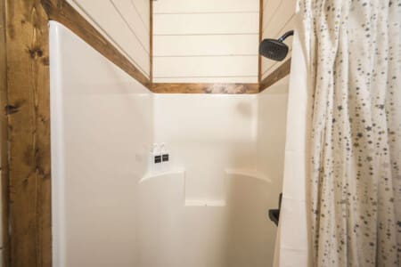 A starry-shower-nook-with-wooden-trim.jpg