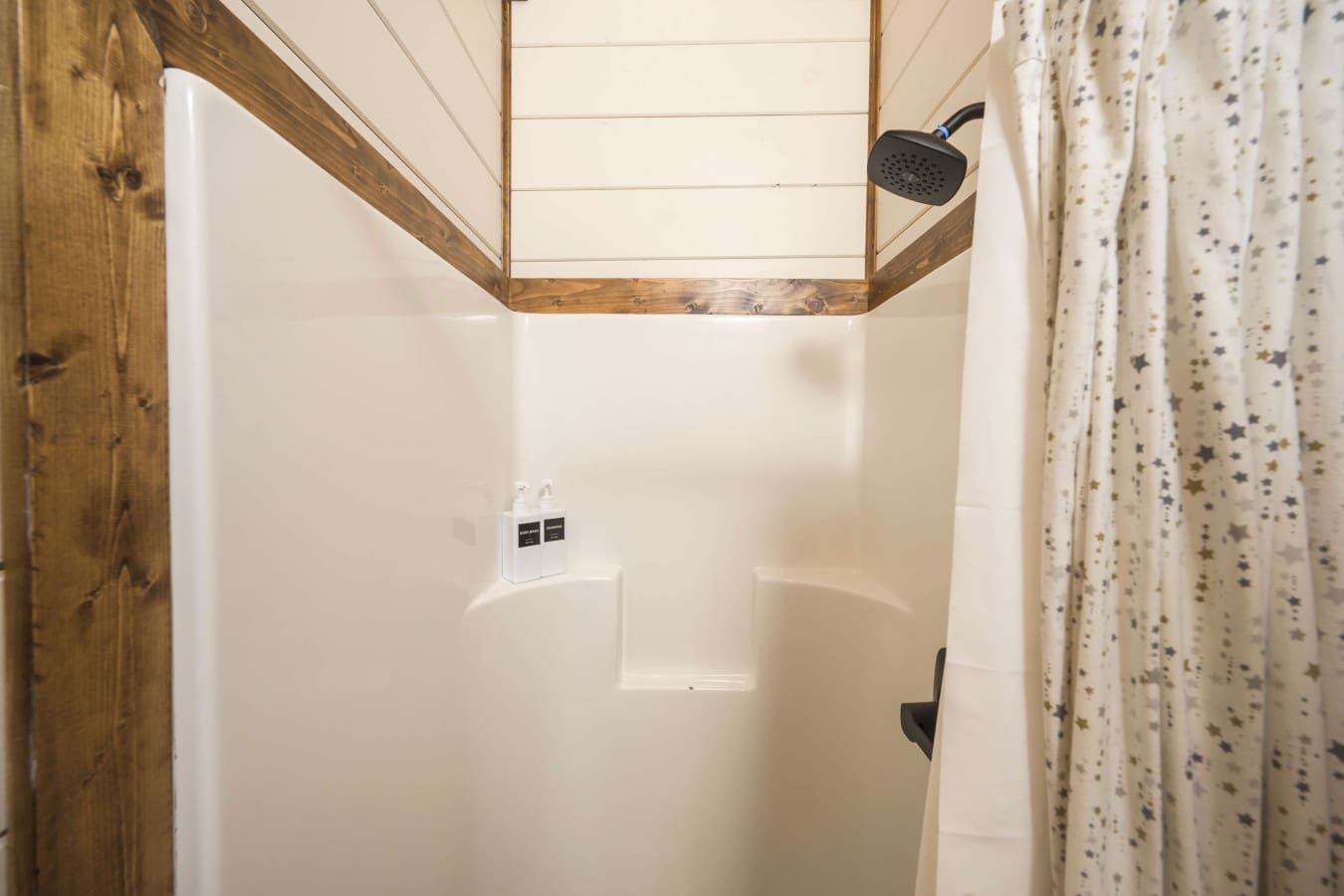 A starry-shower-nook-with-wooden-trim.jpg