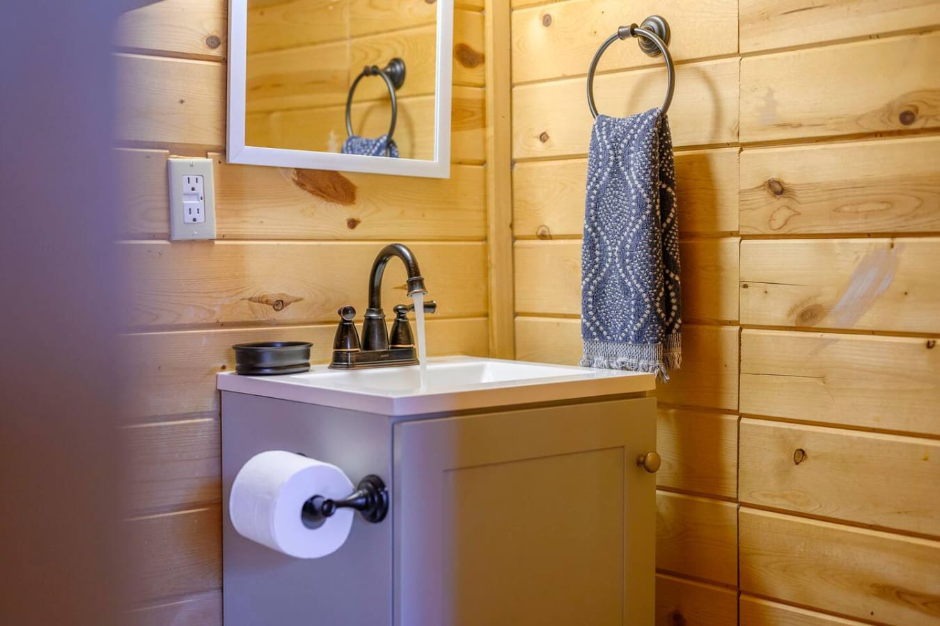 Toilet paper holder conveniently placed for easy access and added bathroom functionality.