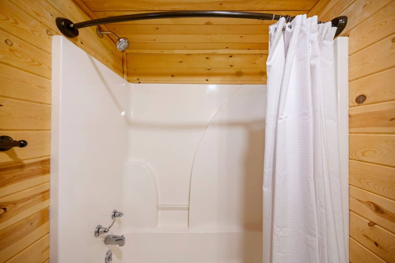 Clean and functional shower curtain providing privacy and keeping the bathroom neat and comfortable.