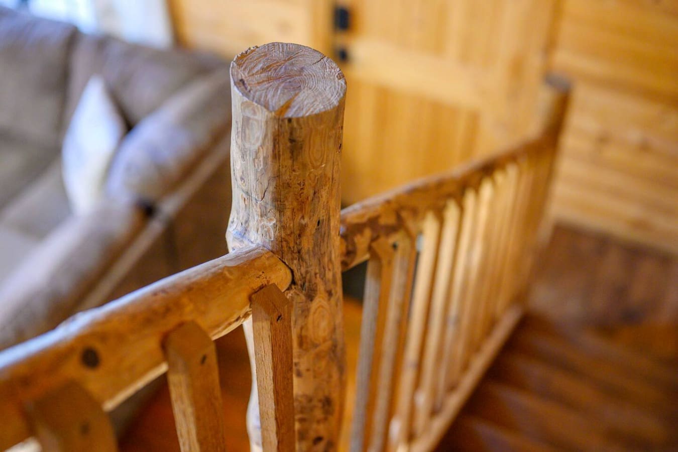 Sturdy wooden railing providing safety and adding a warm, natural design touch to the staircase or balcony area.