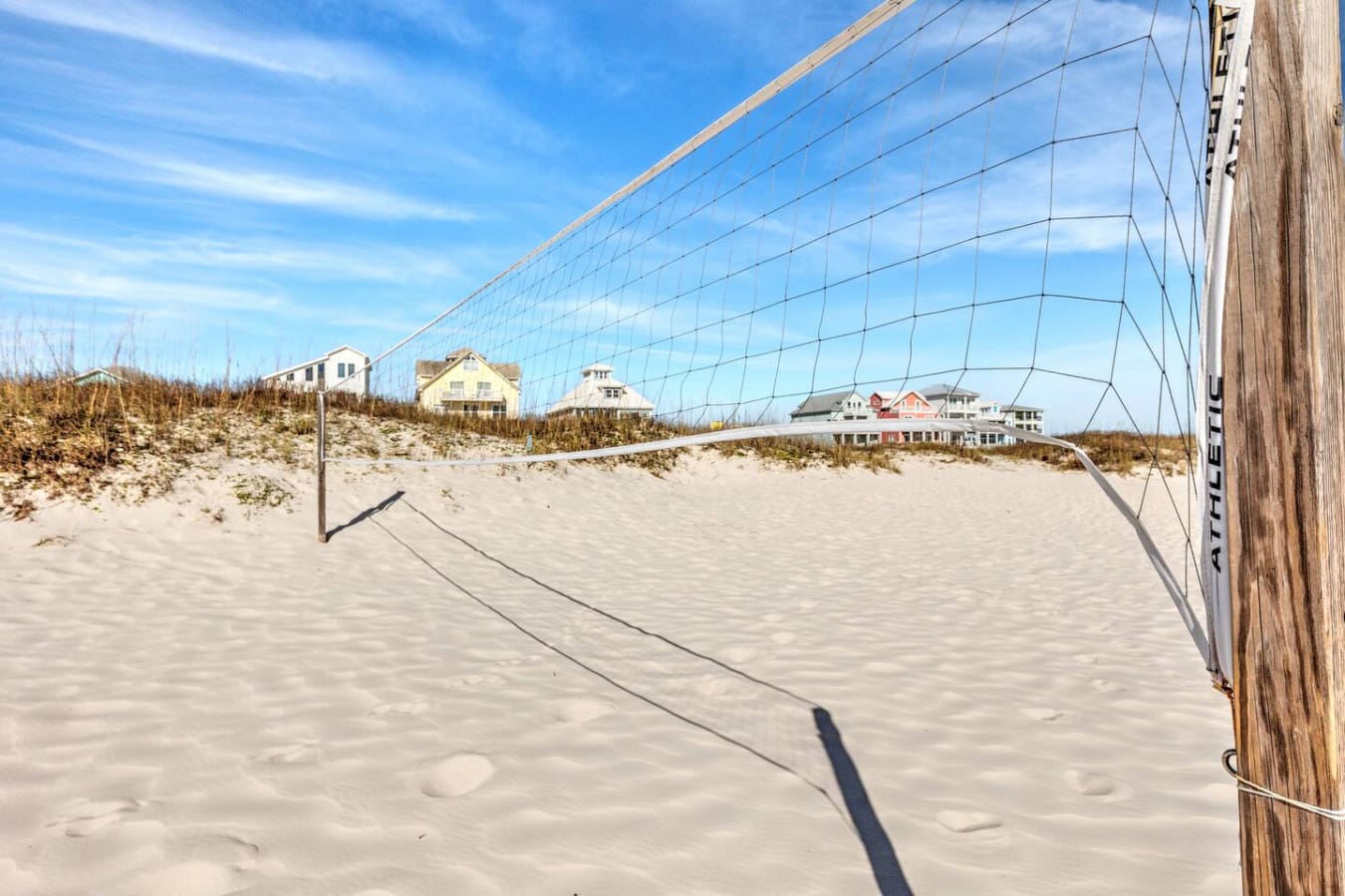 Nothing beats a good game of beach volleyball with a view of those colorful coastal homes rising up behind the dunes.