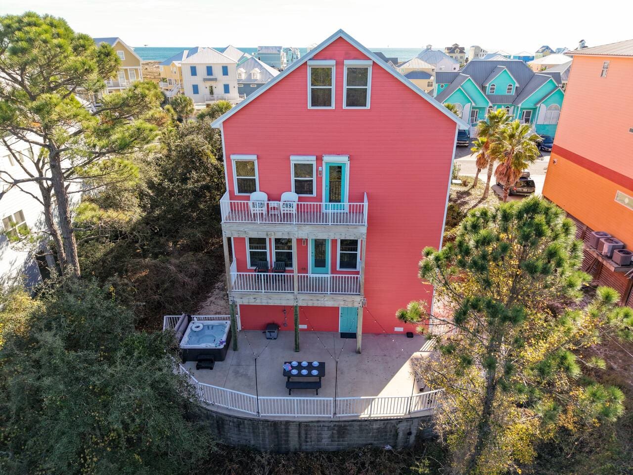 This bold red three-story beach house sits right in the heart of a vibrant coastal neighborhood, with its own private courtyard and plenty of deck space to take in all those colorful homes around you.