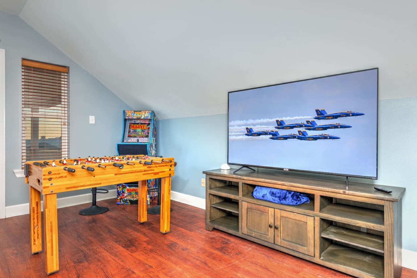 This game room is basically the ultimate hideaway for the crew—foosball, arcade games, a massive flat-screen, and enough space to keep everyone entertained for hours.