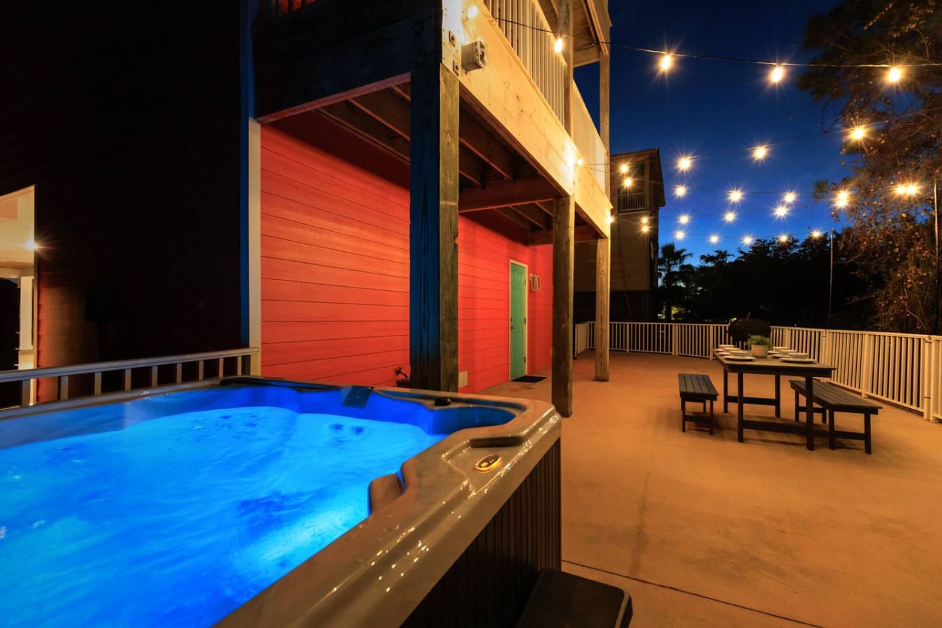 This elevated deck is basically made for sunset soaks in your own glowing hot tub while the whole neighborhood lights up around you and those string lights work their magic overhead.