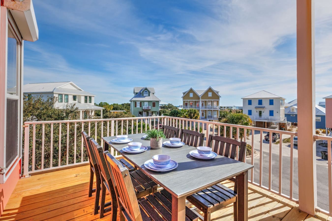 This elevated deck is basically made for watching the sunset over a neighborhood full of colorful beach houses while that coastal breeze keeps things perfectly cool.