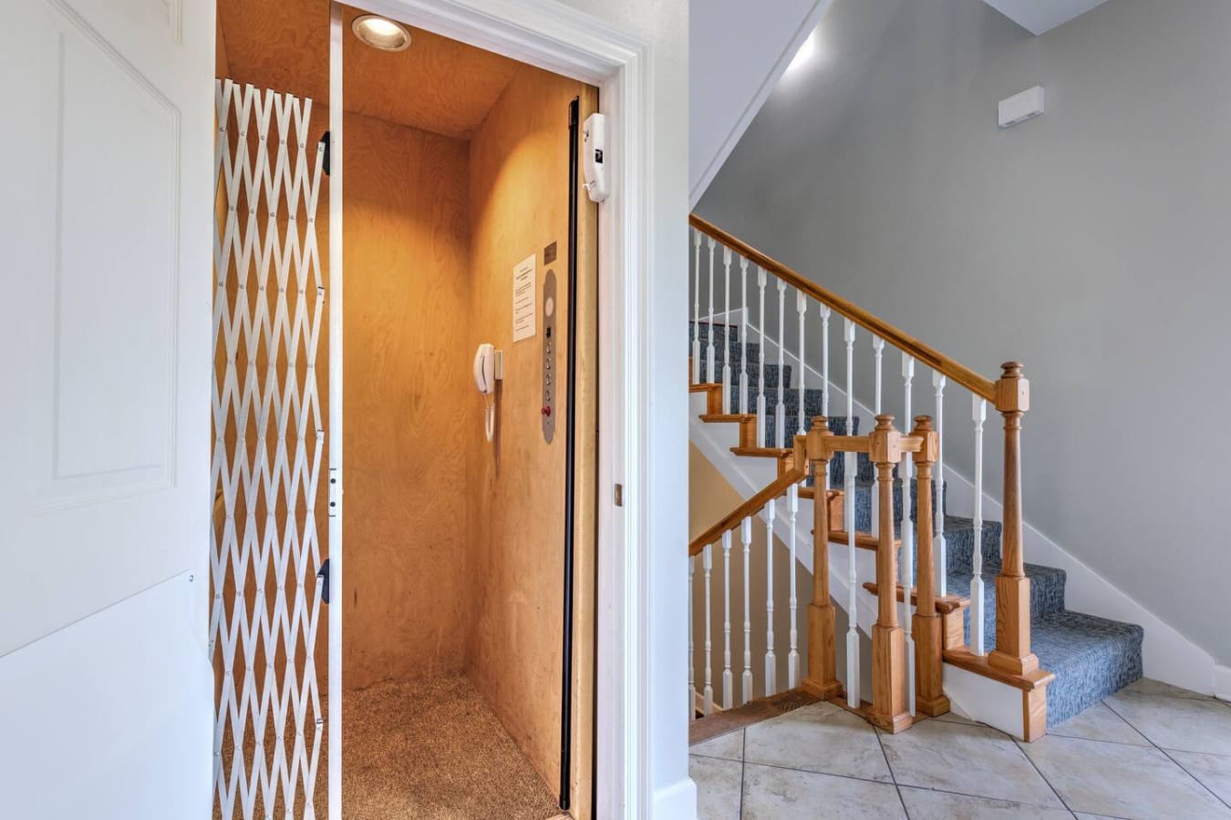 This sleek home elevator and bright stairwell are perfect for moving between levels without breaking a sweat, especially if you've got luggage or anyone who prefers to skip the stairs.