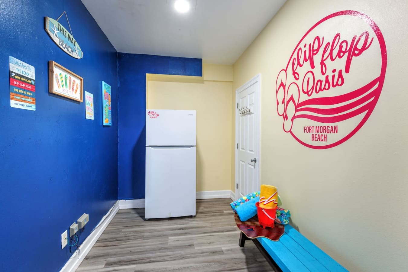 This colorful beach oasis has a fun, laid-back vibe with that bright pink "Flip Flop Oasis" sign and beachy decor that basically screams "you're officially on vacation now."