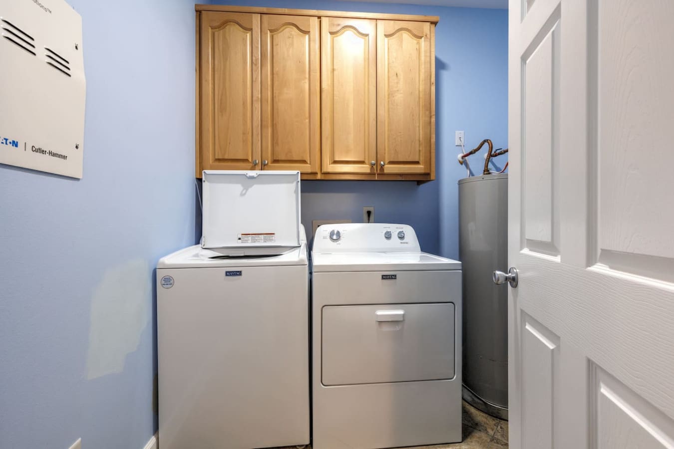 Your laundry room is fully stocked and ready to go, with plenty of cabinet storage, a washer and dryer, and natural light to make tackling those vacation loads actually bearable.