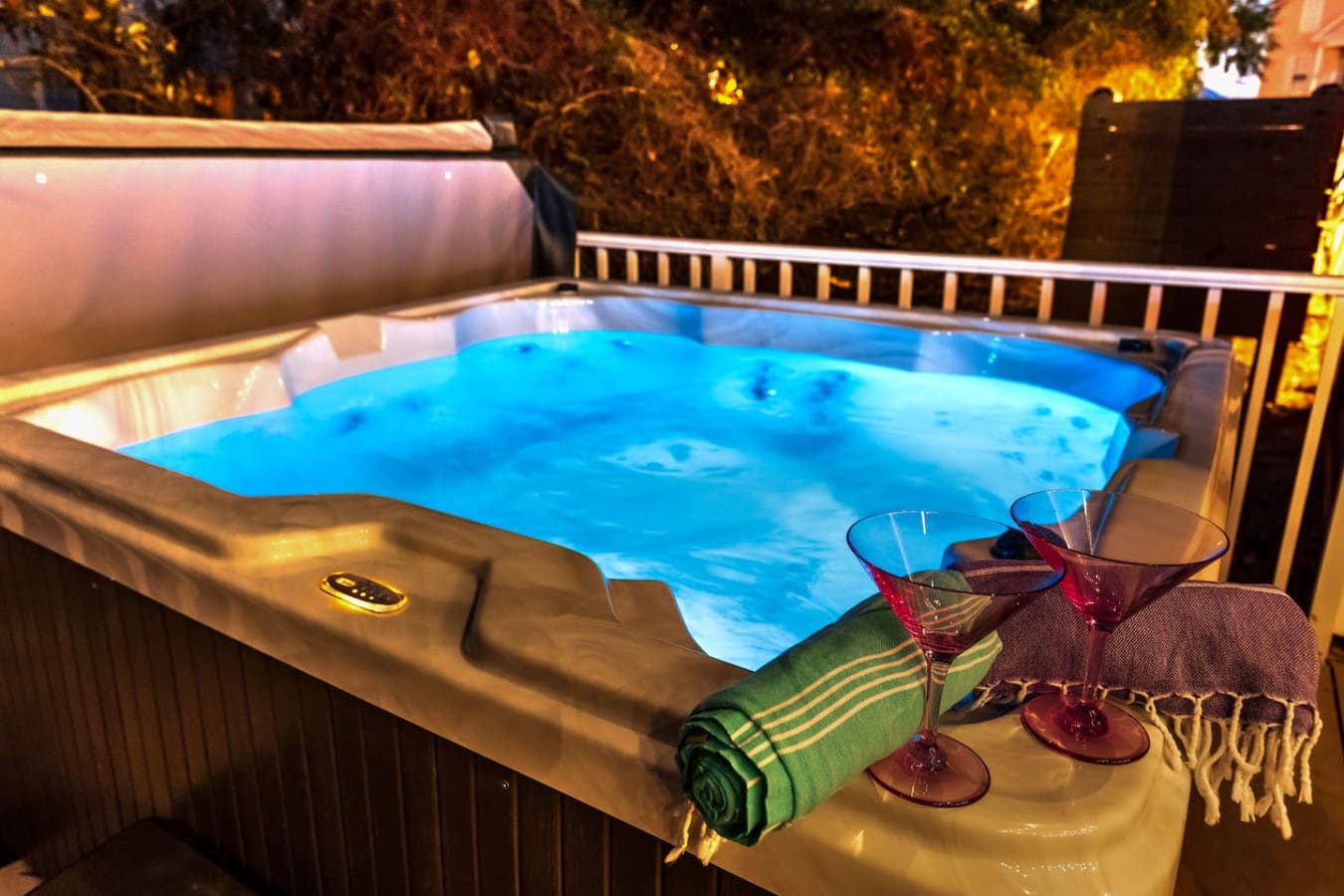 Nothing says "treat yourself" quite like soaking in your own glowing hot tub while the trees light up around you at night.
