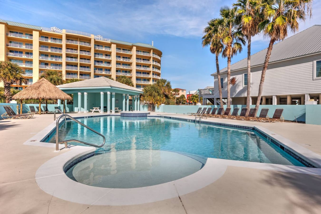 This peaceful resort-style pool area with that cute cabana and spa is pretty much the definition of a relaxing beach getaway without ever leaving your vacation spot.