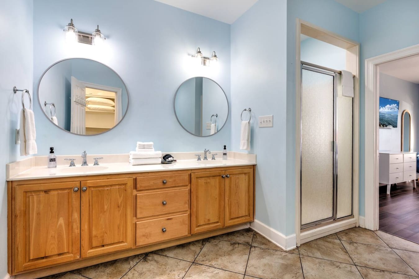 This spacious master bathroom has everything you need to feel pampered with that gorgeous long vanity, dual sinks, and those perfectly framed mirrors that'll make getting ready actually feel luxurious.
