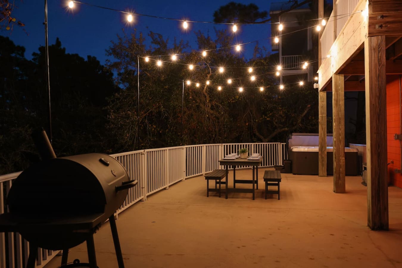 Picture this—string lights twinkling overhead, a cozy fire pit ready to go, and your whole crew gathered on this sprawling deck like you've rented out your own private corner of paradise.