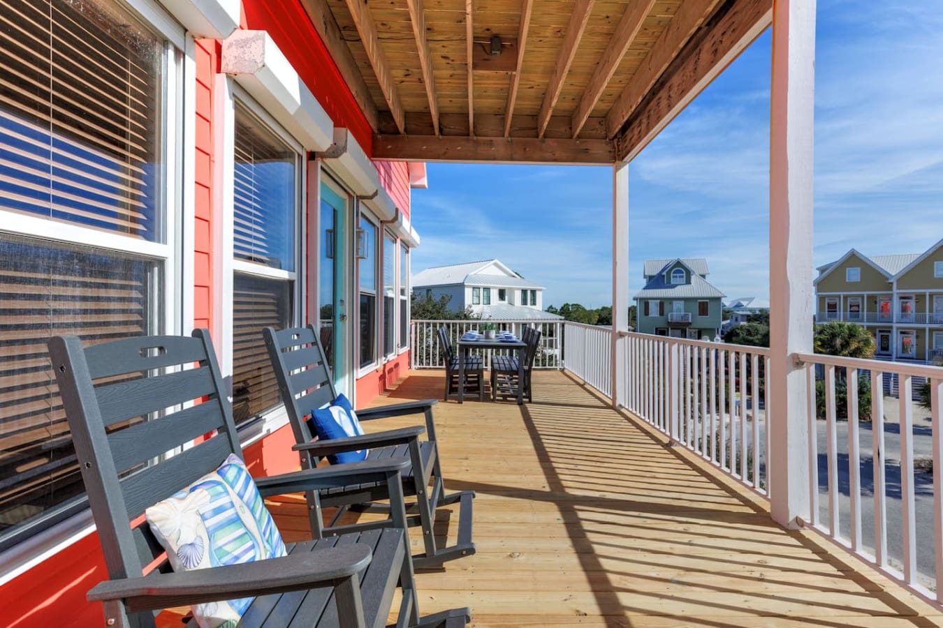Wake up on this sprawling deck, grab one of those comfy chairs, and spend your whole day watching the neighborhood come to life with colorful beach houses and endless sky.