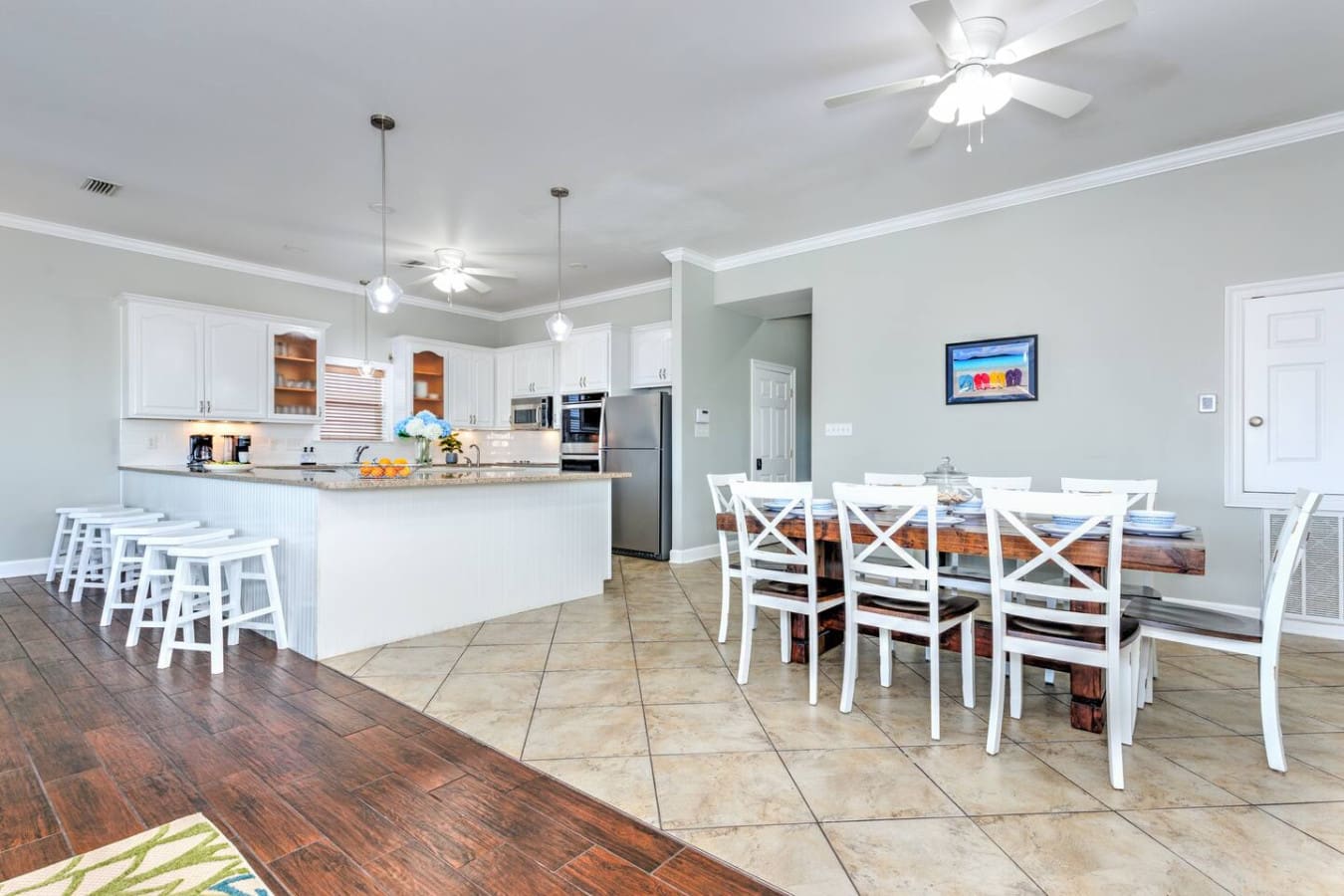 This open-concept kitchen and dining area is basically made for gathering the whole crew around that big table while everyone can keep an eye on what's cooking at the same time.