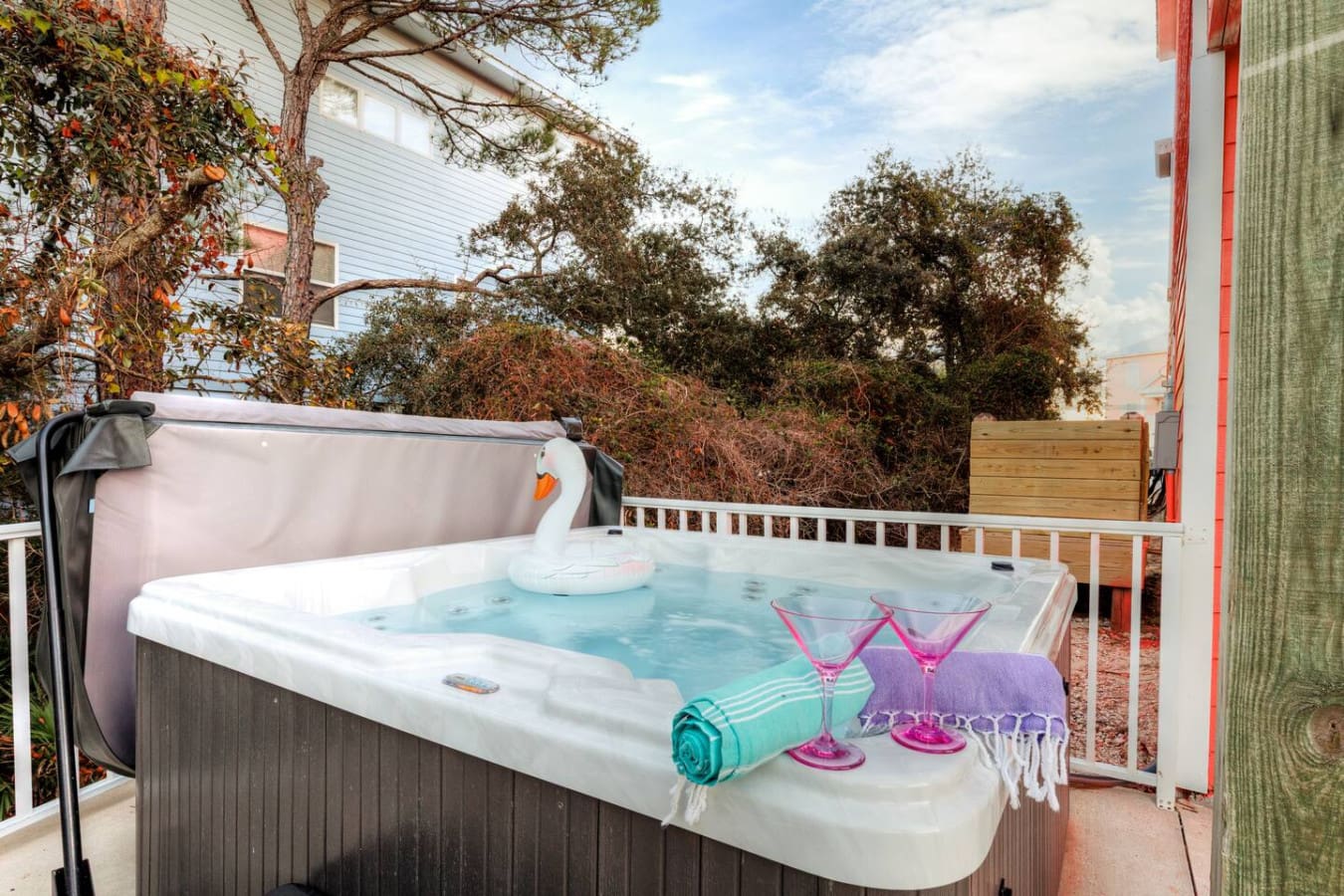 Nothing says "vacation mode activated" like soaking in your own private hot tub on the deck while the trees sway around you and the whole neighborhood glows in that golden evening light.
