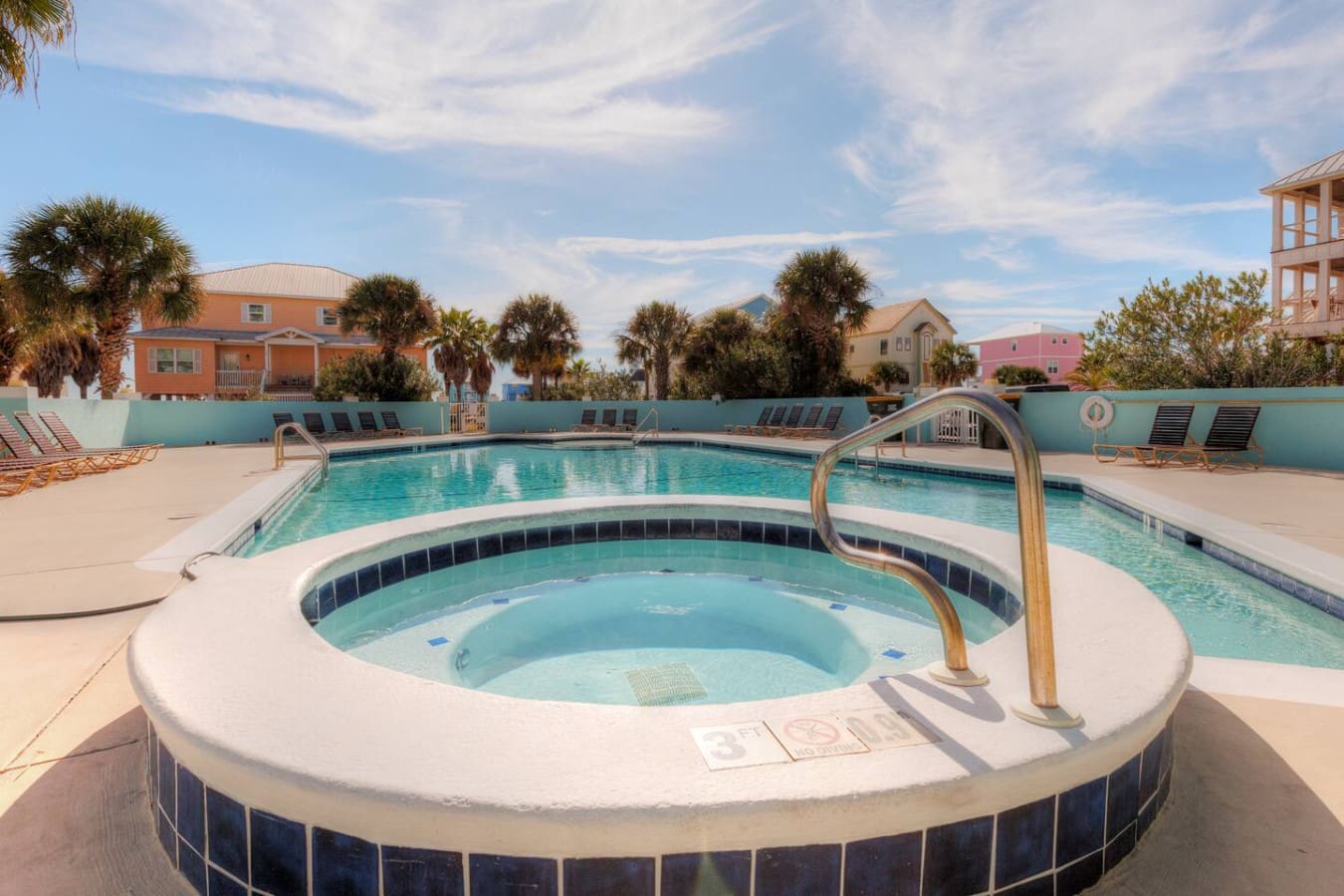 This resort-style pool setup with the hot tub front and center is basically calling your name for those lazy afternoons surrounded by palm trees and that perfect coastal sunshine.
