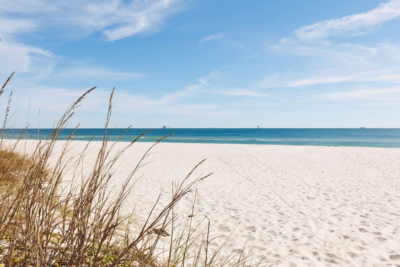 Wake up to dune grass swaying in the breeze and endless ocean views that stretch all the way to the horizon—this is what beach mornings are made of.