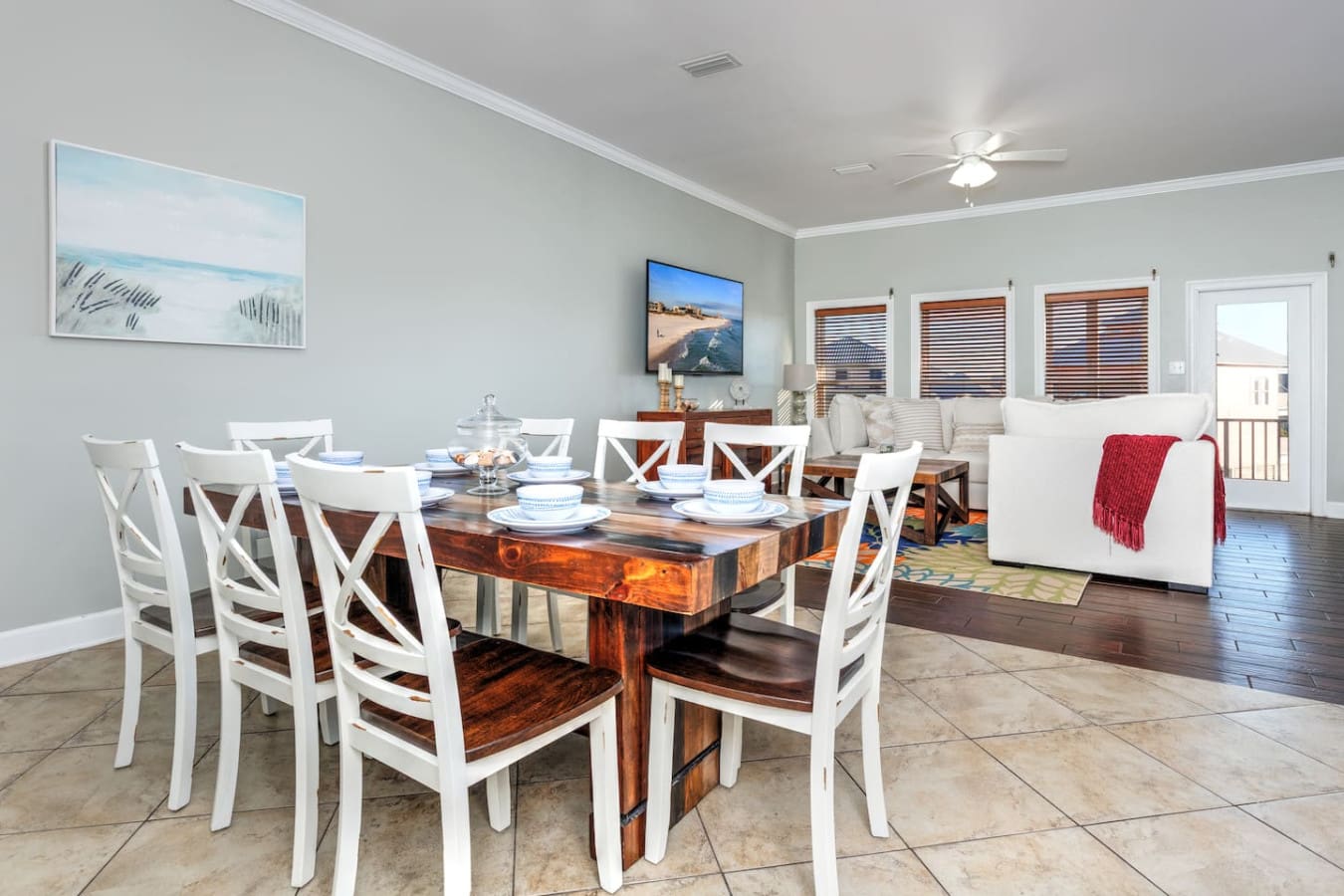 This open-concept dining and living space is basically built for gathering your whole crew around that gorgeous wood table while the ocean views keep everyone happy from every angle.