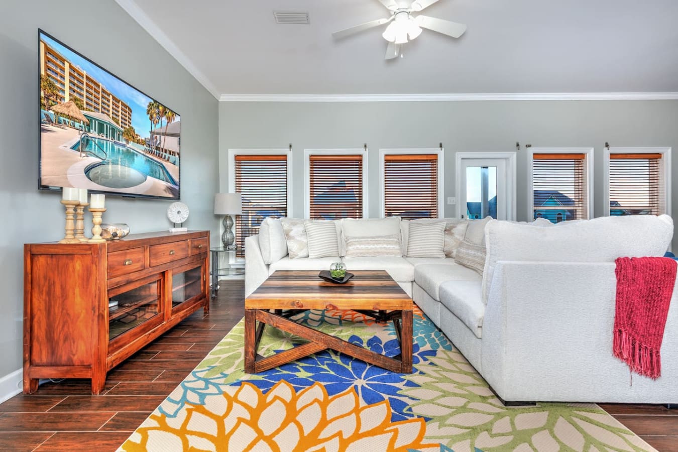 This bright, beachfront living room is basically built for lounging with those floor-to-ceiling glass doors, a super comfy sectional, and views that just keep going.