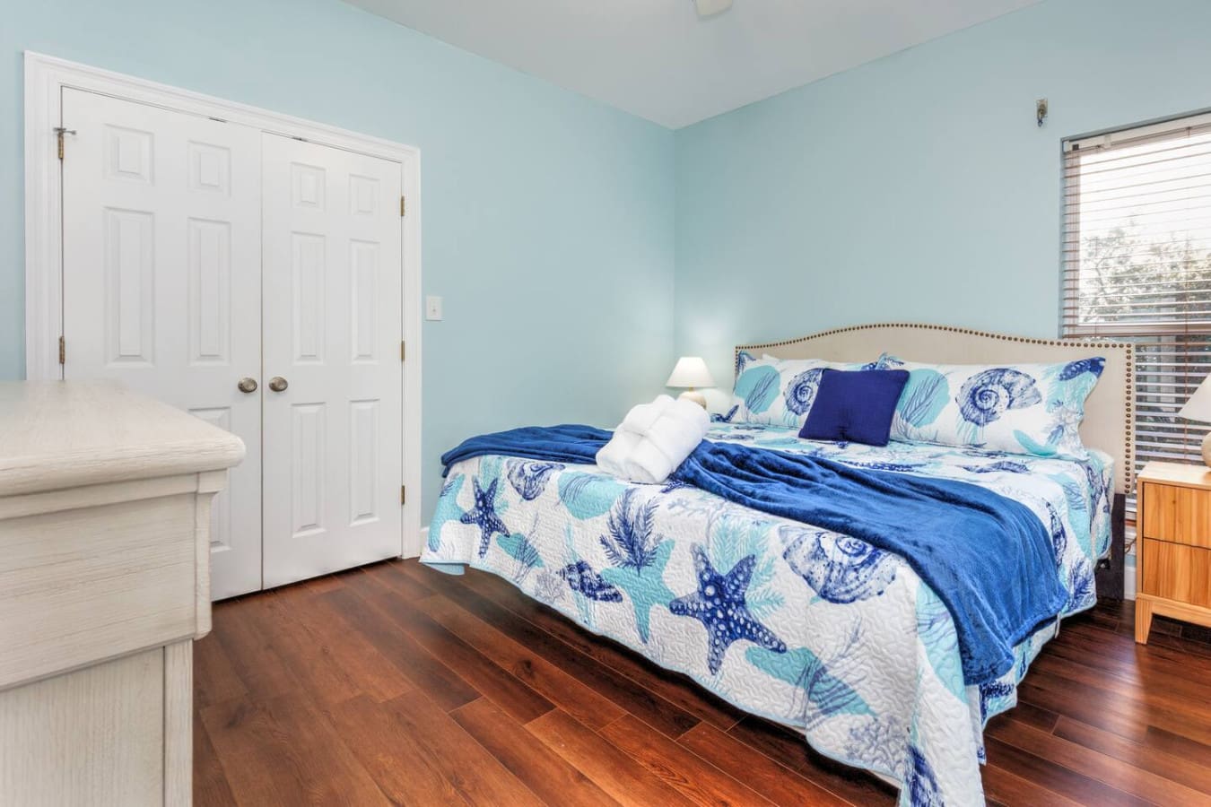 This peaceful bedroom with its soft blue walls and nautical bedding is basically the perfect spot to drift off to the sound of waves and wake up ready for another beach day.