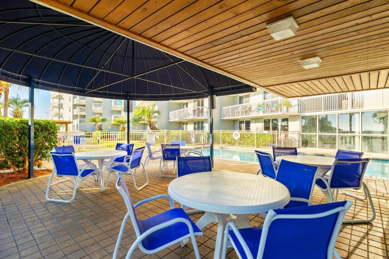 The covered pavilion area is basically your own private oasis—shaded seating, unobstructed pool and ocean views, and that perfect blend of lounging comfort without the scorching sun beating down on you.