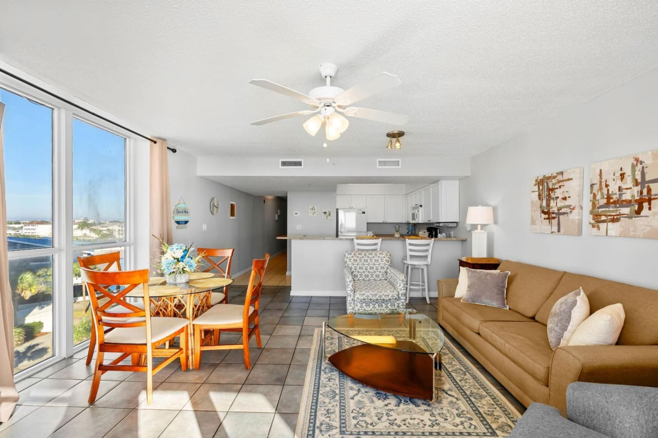 This open-concept living space flows seamlessly from your dining area to the kitchen to the living room, all while those floor-to-ceiling windows keep the ocean view front and center no matter where you're sitting.