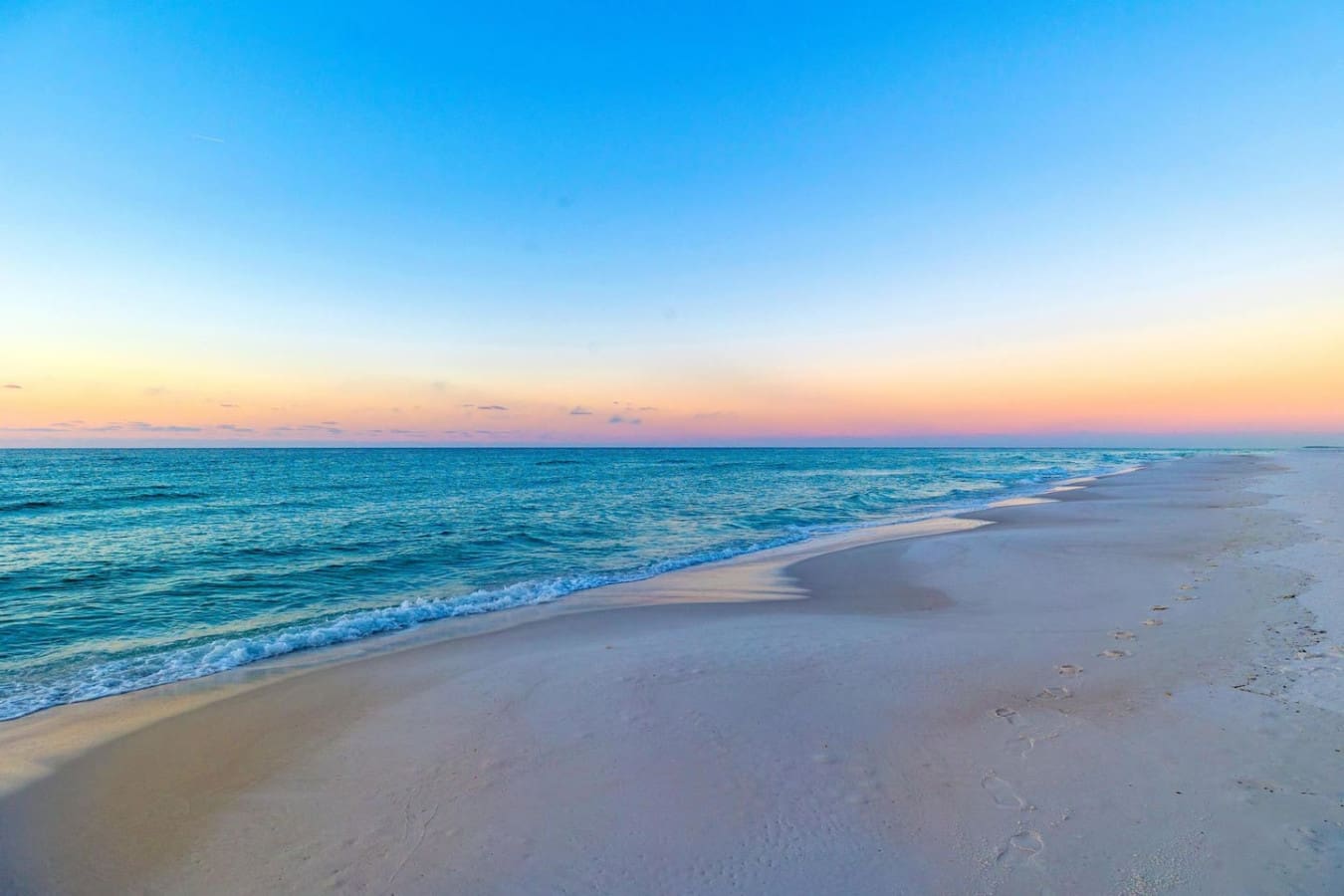 There's something about that quiet stretch of sand at dusk when the sky turns peachy-pink and the waves gently roll in that just makes everything else fade away.