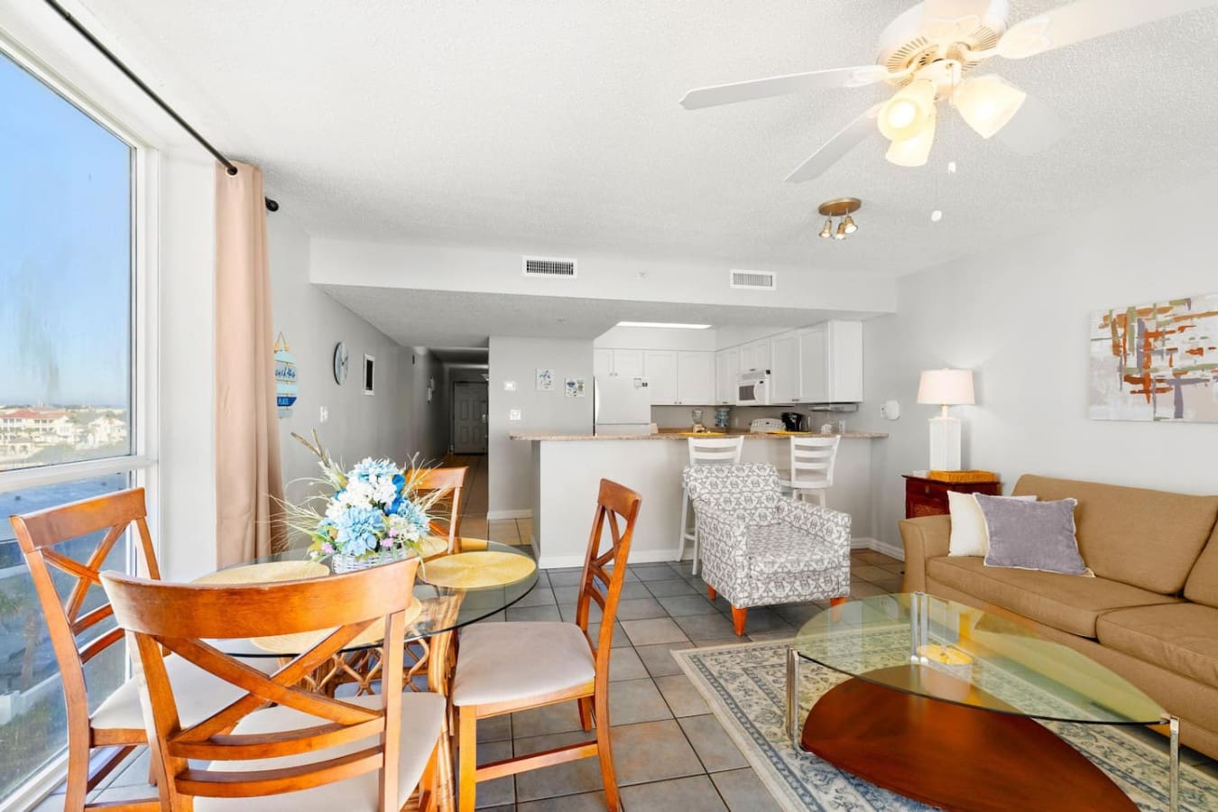 This open-concept living space practically invites the ocean inside, with that seamless layout where you can lounge on the couch, enjoy a meal at the dining table, and still feel connected to the view and breeze from your beachfront perch.