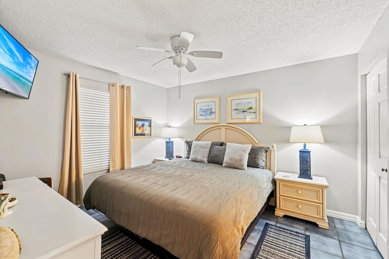 This master bedroom's got that peaceful beachside vibe locked down—natural light flooding in, a comfy bed dressed just right, and everything you need to settle in and actually relax.