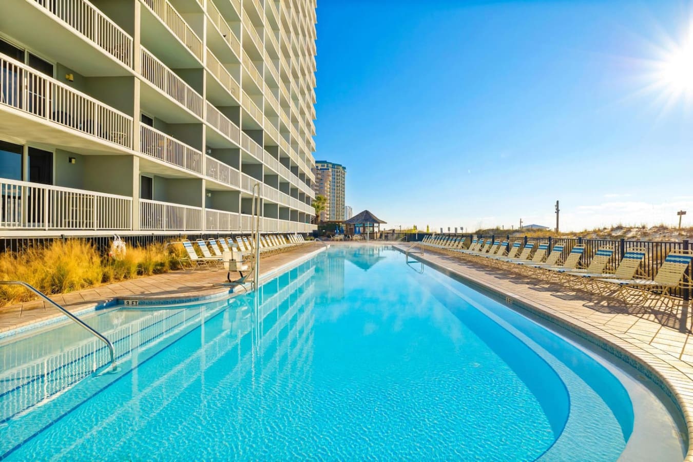 Dive into this sparkling Olympic-length pool with that endless blue sky overhead and the whole resort stretched out around you—it's the kind of setup that makes you forget how to count the days.