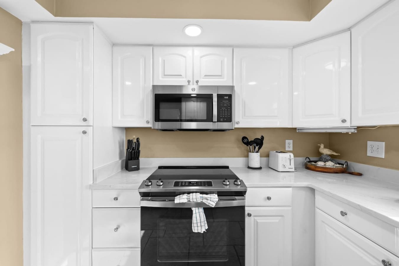 Modern kitchen space featuring essential appliances, storage cabinets, and a practical layout for comfortable meal preparation.