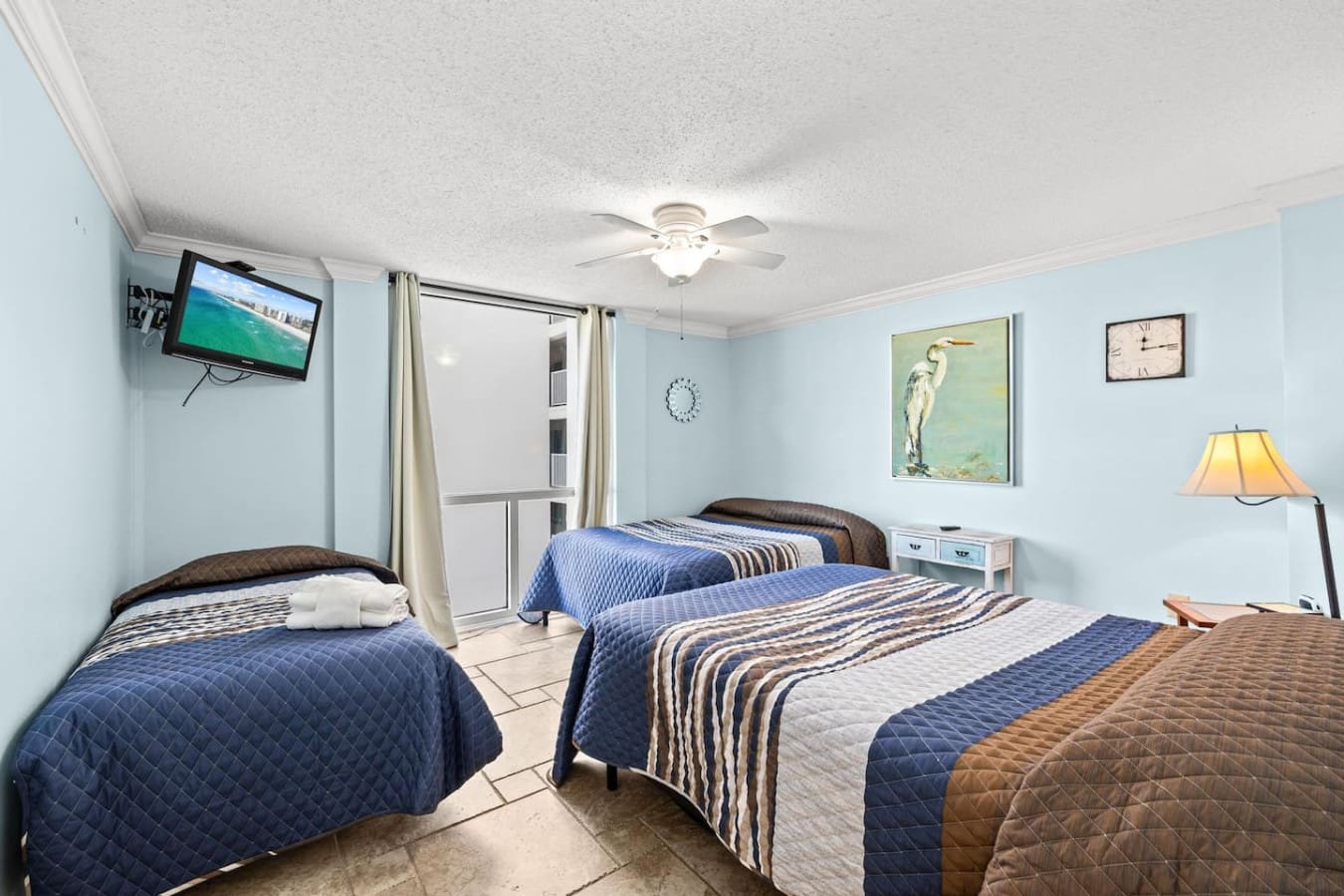 Three comfortable beds in the room, providing ample sleeping space and a convenient setup for families or small groups.