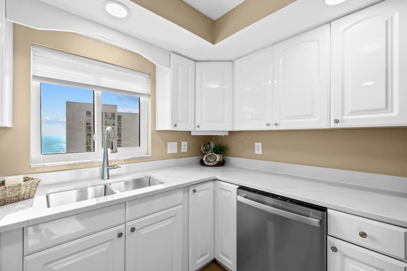 Clean white cupboards offering stylish and convenient storage space for kitchen essentials and supplies.