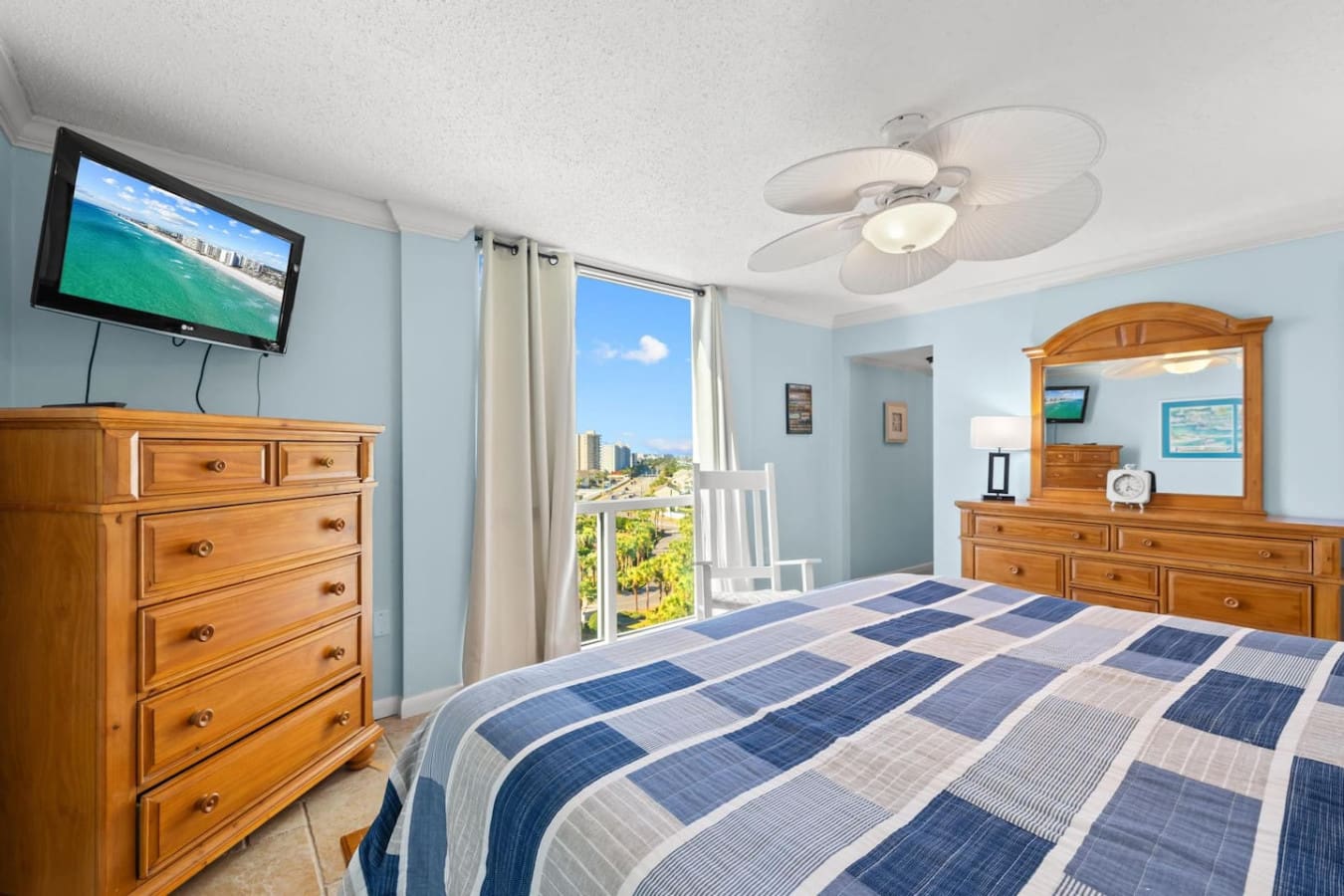 Bedroom equipped with a TV for entertainment and drawers for convenient storage of clothing and personal items.