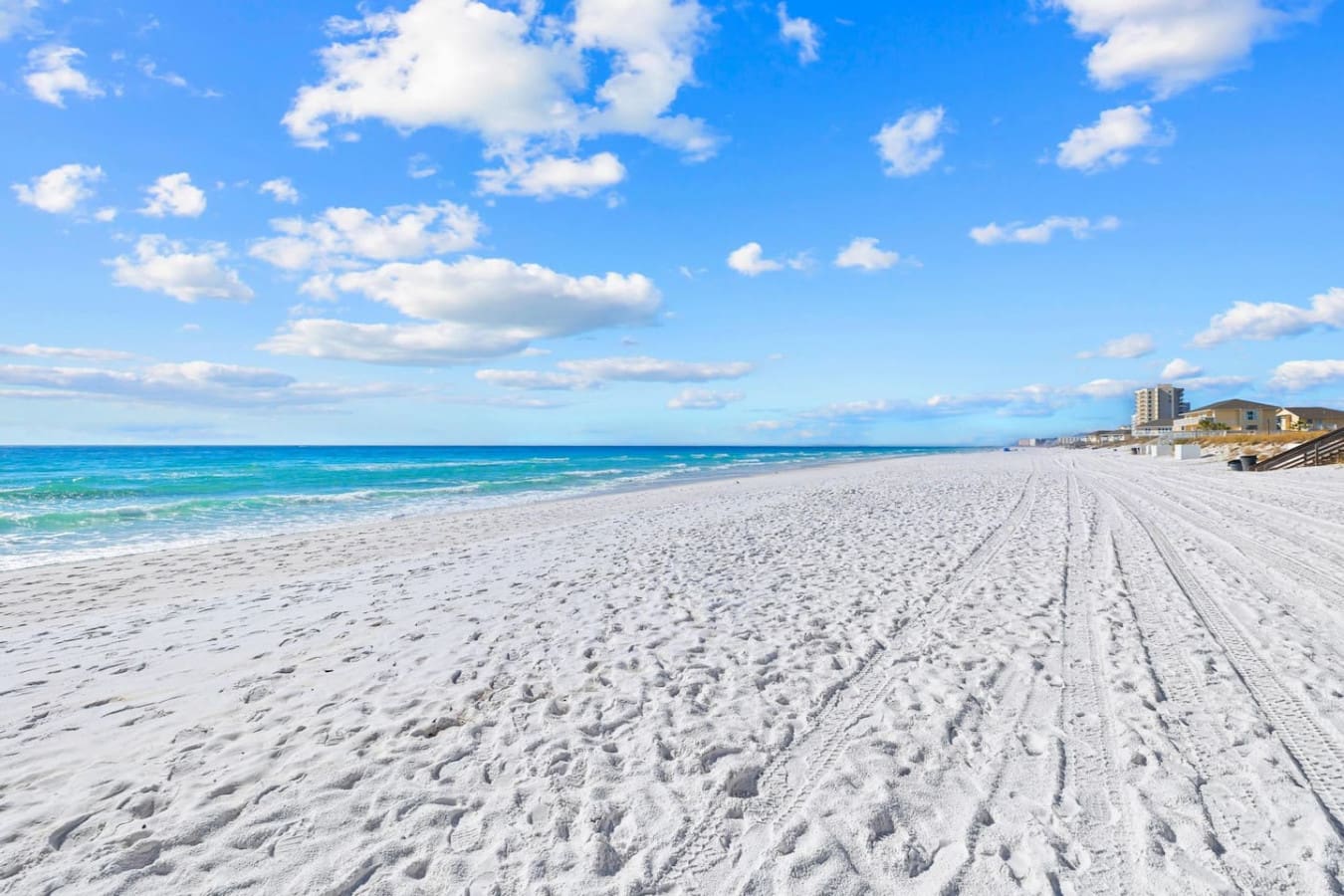 Soft white sand that feels comfortable underfoot, perfect for relaxing, walking along the shoreline, or enjoying a day by the water.