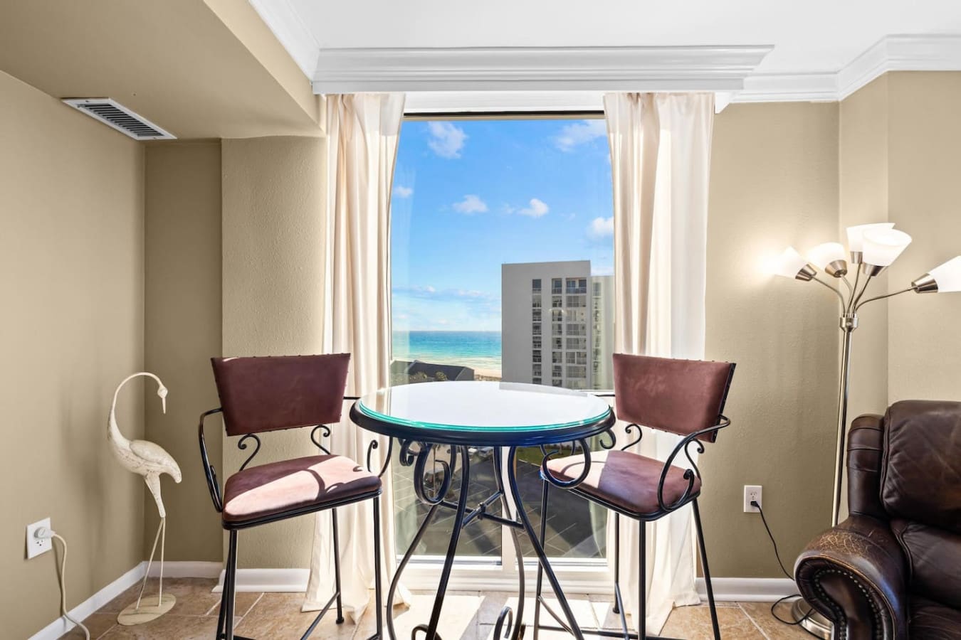 Ocean view visible through a large glass window, allowing you to enjoy the beauty of the sea while staying comfortably indoors.