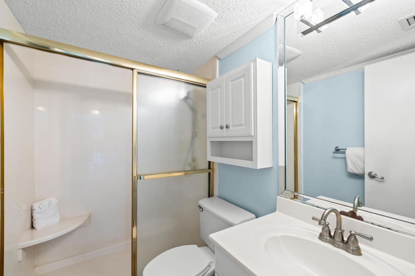 Bathroom with a convenient storage cabinet, providing space to neatly organize toiletries and essential items during your stay.