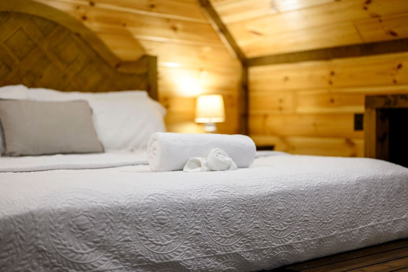 This cozy log cabin bedroom has all the rustic charm you need for a perfect mountain getaway.